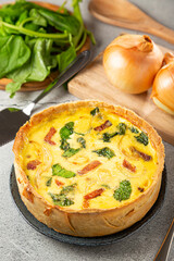 Spinach quiche with onion and bacon.