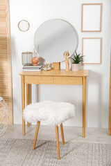 Modern wooden dressing table with mirror and stool in room