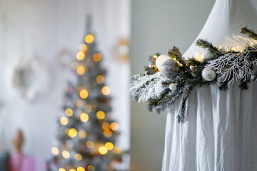 Christmas tree decorated with balls with stars, snowballs, sparkling candle lights. Magical festive night. Tent with fir branches in the interior of the living room
