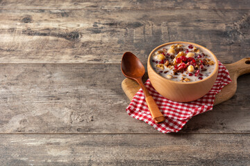 Traditional Turkish Noah's pudding in bowl on wooden table. Copy space	
