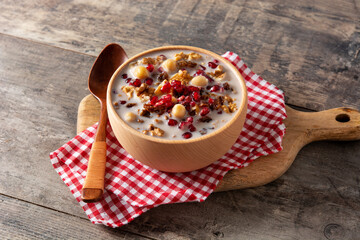 Traditional Turkish Noah's pudding in bowl on wooden table	
