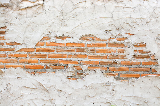 Background Texture of broken or Unfinished Concrete and red Brick Wall