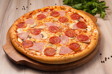pizza with cheese, ham, pepperoni and mushrooms