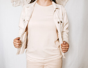 Woman mockup in blank beige t-shirt and jacket on the boho background
