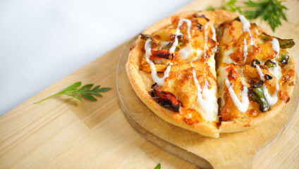Italian pizza with some tasty topping on it. a studio shot of a delicious food served on the wooden peel with copy space.