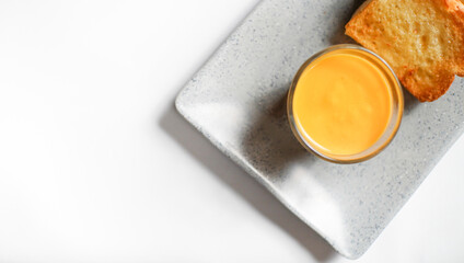 the golden brown toasted bread served with a cup of cheese sauce. a shot of a kind of breakfast menu for western with copy space.