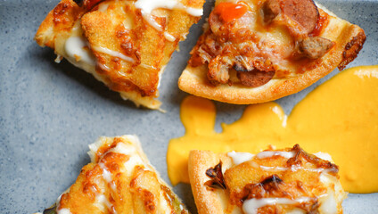 four slices of Italian pizza with some tasty topping on it served with a cheese sauce. a studio shot of a delicious food.