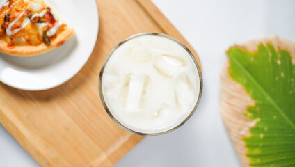 an ice milk and a slice of pizza served as a breakfast menu shot from the top view. a kind of breakfast for western people.
