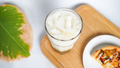 an ice milk and a slice of pizza served as a breakfast menu. a kind of breakfast for western people.