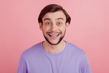 Photo of young cheerful man happy positive smile laugh humor joke isolated over pink color background