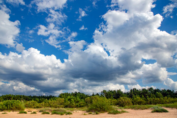 Panorama of the warm Gulf of Riga of the Baltic Sea against the background of cumulus clouds. The coast of the Gulf of Riga in Latvia is popular with tourists.