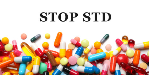 Different pills and text STOP STD on white background, top view. Banner design