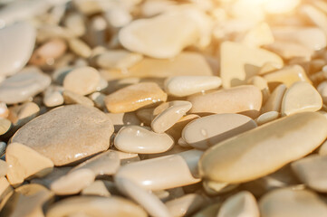 Sea pebble gravel beach, transparent sea. View from the top. Selective focus, toned colores.