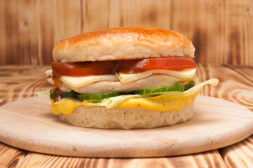 burger with chicken fillet, cheese, tomatoes, cucumbers and tomatoes