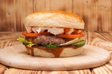 burger with beef patty, cucumbers, tomatoes and cream cheese