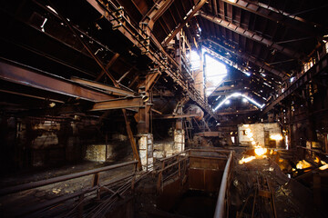 Old rusty abandoned metallurgical plant. Ruined blast furnace
