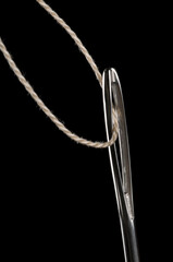 Sewing needle and thread, low key isolated