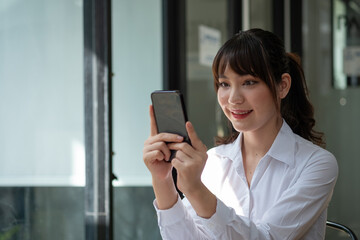 Fototapeta na wymiar Close up woman use of smart phone, charming asian girl video call via mobile phone