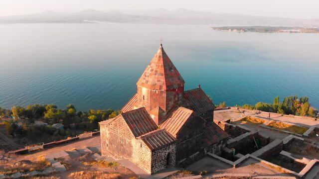 Aerial view Sevanavank armenian monastery complex in Sevan city with blue lake panorama at sunrise . Famous landmark sightseeing in caucasus. Armenia travel concept