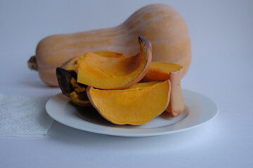 baked pumpkin. yellow pumpkin on a white plate