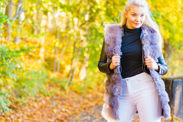 Fashion woman walking in autumn park