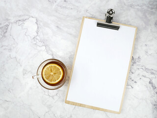 Lemon tea with a paper board on a marble texture background.