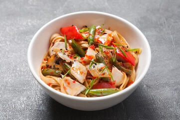 udon with chicken and vegetables in sweet and sour sauce