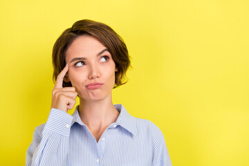 Photo of young attractive woman finger touch head think memory idea look empty space isolated over...