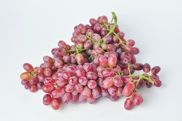 bunch of fresh seedless red grapes isolated on white background.