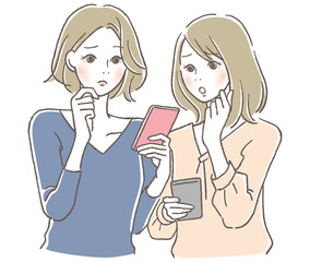 スマホを見て困る女性2人