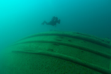 Diver exploring a Great Lakes tugboat shipwreck found in Lake Superior