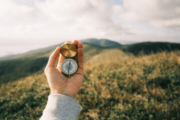 Travel concept. Vintage compass in hands in the mountains. - 466915962