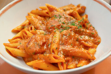 Closeup Penne Pasta with Shrimp and Spicy Arrabbiata Sauce in a White Bowl