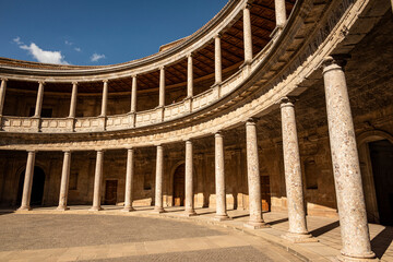 The unique circular patio of the Palace of Charles V (Palacio de Carlos V) with its two levels of columns in form of Doric and Ionic colonnades, Alhambra de Granada, Andalusia, Spain