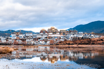 Reflection on the lake of Songzanlin Temple in Shangri-La, Yunnan, China