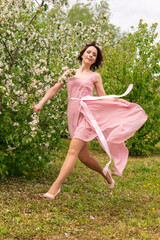 A woman near a blooming spring tree. Romantic happy mood.