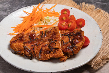 Tonkatsu pork cutlet with vegetables salad, Japanese food on gray background