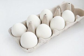 Chicken white eggs close-up top view. Eggs in a cardboard box.