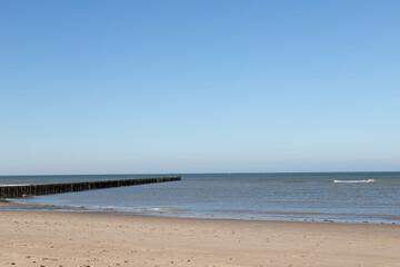 Domburg beach with wooden piles, blue sky and no people