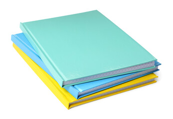 Stack of different colorful hardcover planners on white background