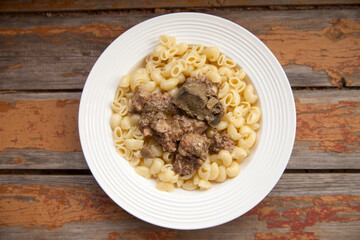 Plate with boiled pasta and chicken liver