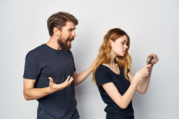 Man and woman with a phone in hand emotions isolated background