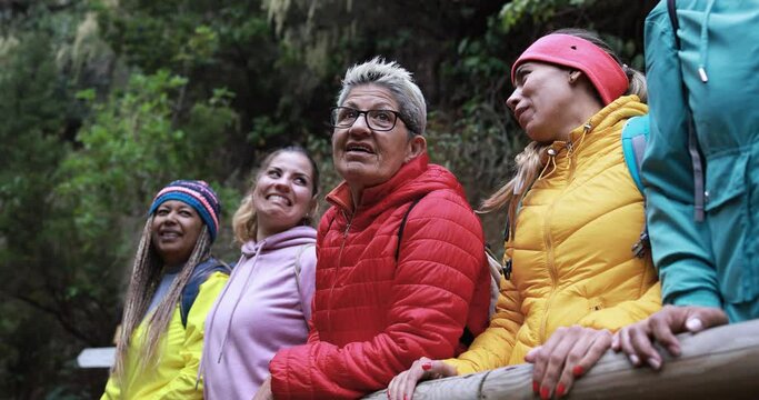 Multiracial women having fun during trekking day in to the wood - Multi generational friends enjoy day in nature