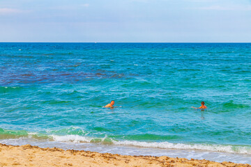 people swim at beach landscape panorama Can Picafort Mallorca Spain.