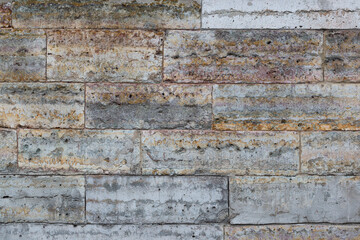 Old wall lined with decorative stone. Weathered rough surface of stones. Beautiful masonry in a classic style. Vintage texture great for background and design.