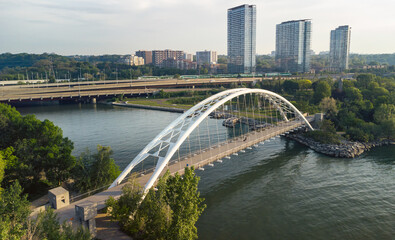 Wide angle aerial view of a waterfront pedestrian bridge