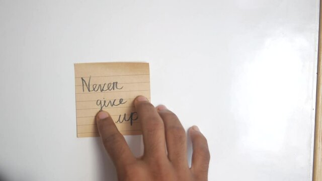 putting never give up word on a white board 