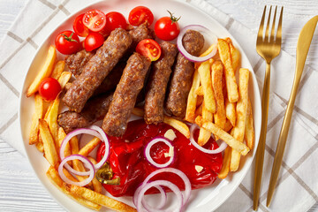 cevapcici with potato fries, red pepper, tomatoes