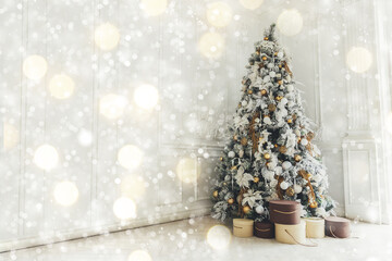 Classic Christmas decorated interior room New year tree. Christmas tree with gold decorations. Modern white classical style interior design apartment, shiny illumination lights. Christmas eve at home.