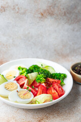 salad buddha bowl boiled egg, broccoli, tomato, cucumber, vegetables meal snack on the table copy space food background veggie vegan or vegetarian 